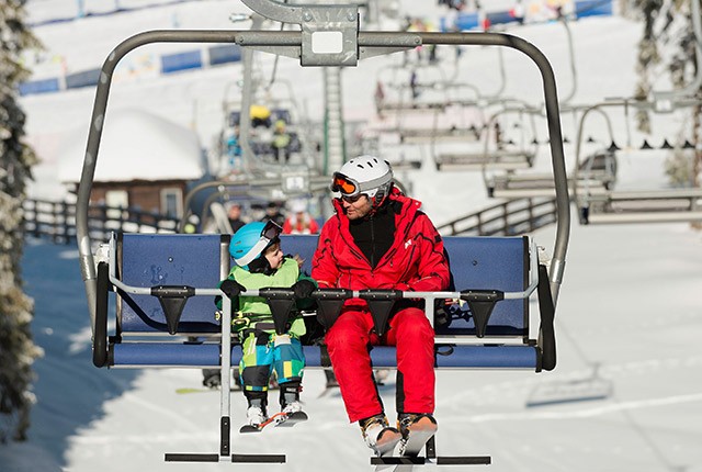 Father and son on chairlift.