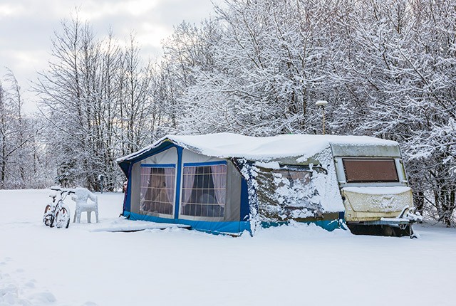 Winter camping camper and tent in the snow. Wintercamping.