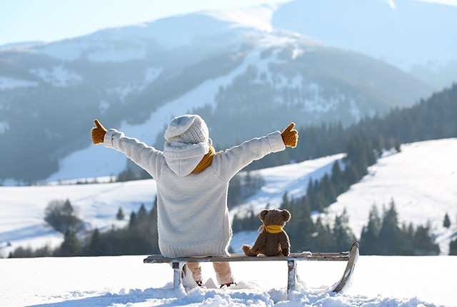 DE_young girl facing mountains arms open with teddy bear. Rodelbahn Oberösterreich. 